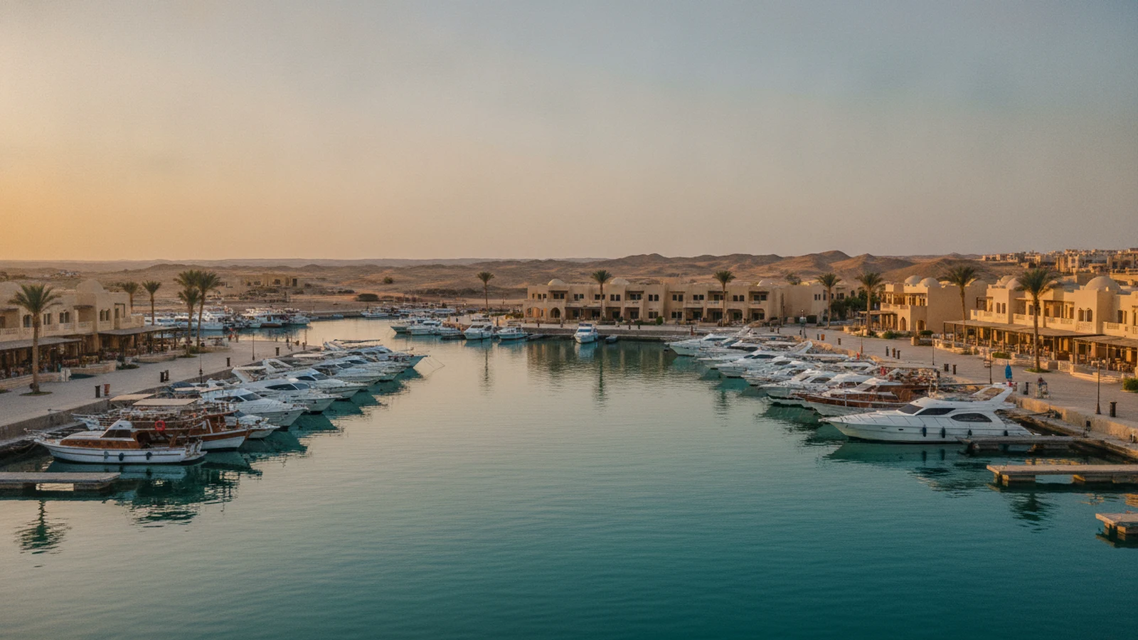 Marina Port Ghalib u Marsa Alam s jachtami a nízkou pískovou zástavbou na korniche